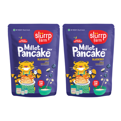 Two packages of Slurrp Farm Millet Pancake Mix with a tiger character 