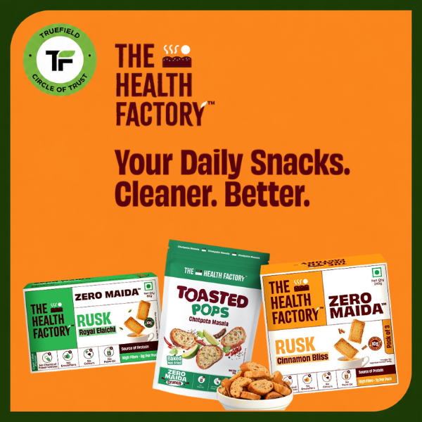 Promotional graphic for The Health Factory snacks on an orange background with a green border.  (mobile)